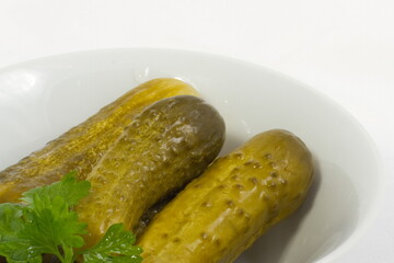 Pickled cucumbers in a white bowl