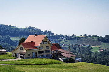 Fototapeta na wymiar Alpine mountains landscape. Traditional farm house with wonderfull view.