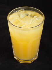 Pineapple juice with ice cubes in a glass Cup