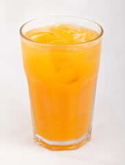 Peach juice with ice cubes in a glass Cup