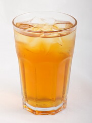 Apple juice with ice cubes in a glass Cup