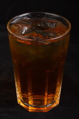 Apple juice with ice cubes in a glass Cup