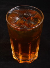 Apple juice with ice cubes in a glass Cup