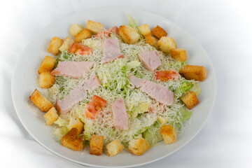 Caesar salad with Turkey on a white plate