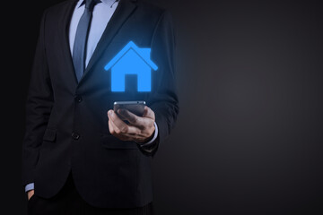 Real estate concept, businessman holding a house icon.House on Hand.Property insurance and security concept. Protecting gesture of man and symbol of house.