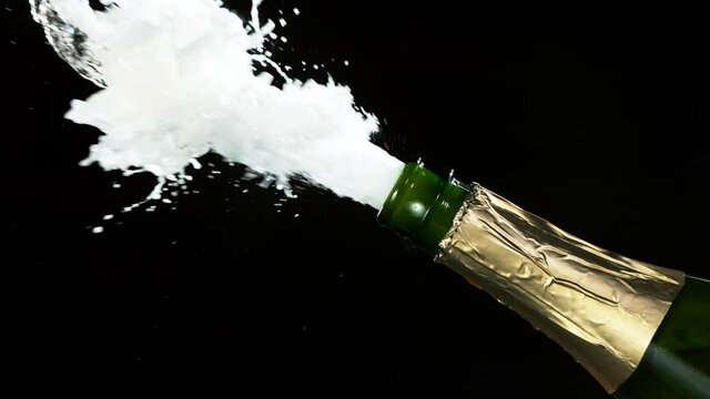 Super slow motion of Champagne explosion, opening champagne bottle closeup. Filmed on high speed cinema camera, 2000fps