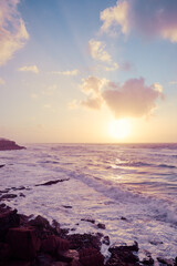 Obraz premium Amazing sunset on Atlantic ocean. Waves and foam.