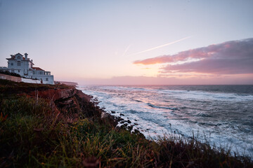 Beautiful sunset in portuguese village on the ocean shore.
