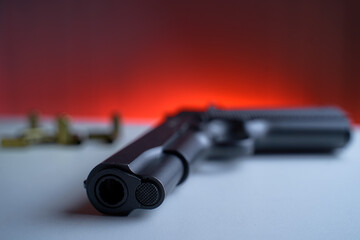 Obraz premium Big black gun pistol on white table.