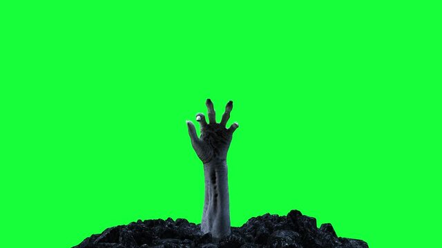 Zombie hand crawling out of the ground on a green screen