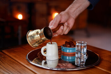 Fototapeta na wymiar Traditional turkish coffee in cezve on metal tray.