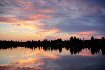 Lake in beautiful sunset time with wonderful sky reflecting in water.