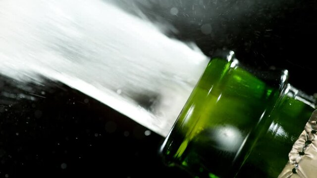 Super slow motion of Champagne explosion, opening champagne bottle closeup. Filmed on high speed cinema camera, 1000fps