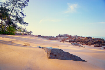 Fototapeta na wymiar Beautiful beach with golden sand, rocks and blue sky.