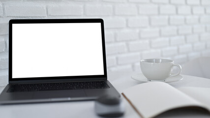 Laptop mockup blank screen and coffee mug on workspace.