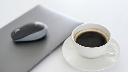 Fototapeta na wymiar White coffee cup with laptop on white floor.