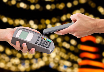 Payment on a trade through contactless card and NFC technology. Front view. Horizontal composition.