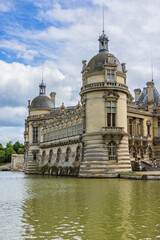 Fototapeta na wymiar Architectural fragments of famous Chateau de Chantilly (Chantilly Castle, 1560) - a historic chateau located in town of Chantilly, Oise, Picardie, France.