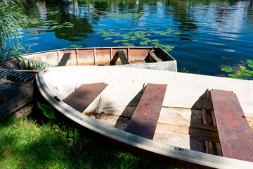 Old rowing boat on shore, river Waal. Rijsoord, The Netherlands