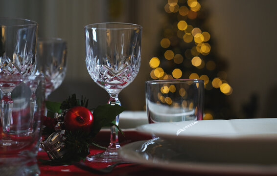 Close up wine glasses at the decorated dinner table for chrismas dinning