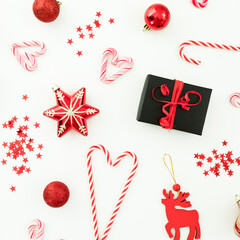 Christmas composition. Gifts, decoration, toys, candy canes and confetti on white. Flat lay