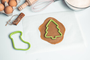 Shortcrust pastry for gingerbread.Christmas background for baking, top down view, copy space. Christmas and New Years, family celebration traditions. cinnamon, spices, flour on a white table.