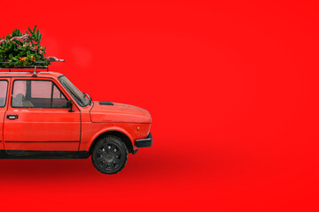 Christmas tree on the roof of the car. Red retro car. Delivery of goods, New Year's trips and...