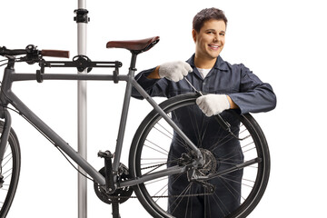 Fototapeta na wymiar Repairman fixing a bicycle on a stand