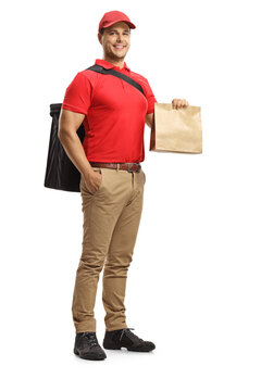 Full Length Portrait Of A Food Delivery Man With A Paper Bag