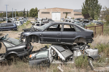 Wrecked cars on a junkyard waiting for recycling
