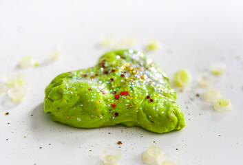 Green heart with shiny glitters made from slime