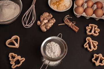 Shortcrust pastry for gingerbread.Christmas background for baking, top down view, copy space. Christmas and New Years, family celebration traditions. cinnamon, spices, flour on a white table.
