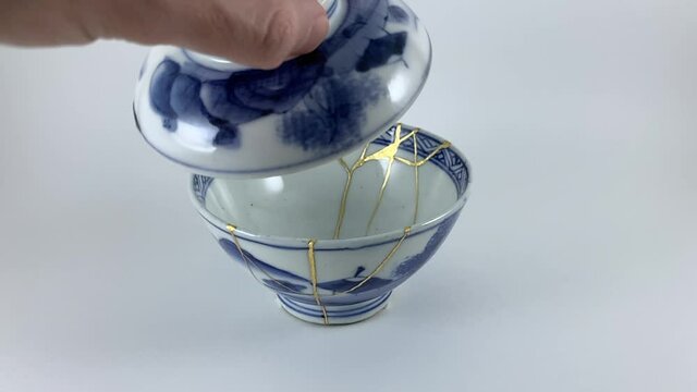 Antique broken Japanese blue bowl repaired with gold kintsugi technique
