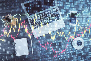 Double exposure of forex chart drawing over table background with computer. Concept of financial research and analysis. Top view.