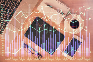 Multi exposure of forex graph hologram over desktop with phone. Top view. Mobile trade platform concept.