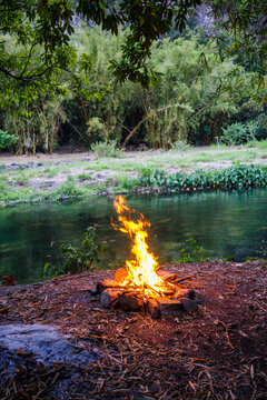 Campfire lit on the banks of the Riviere des Marsouins river in Ilet Coco on Reunion Island