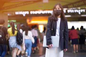 asian office women and laptop with face mask in train station