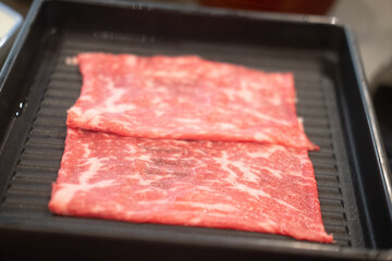 Premium grade of fresh raw thin sliced beef for Shabu Shabu