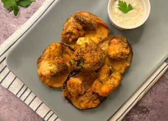 Vegetarian breaded vegetables in breadcrumbs. Zucchini and mushroom with sauce tartare.