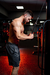 Fit young man lifting weight doing workout at a gym. Sport, fitness, weightlifting, bodybuilding,...