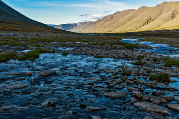 Obraz premium cold stream and mountain range on a summer day