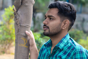 Young man looking left side in the Garden