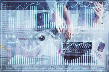 Double exposure of man and woman working together and financial graph hologram drawing. market analysis concept. Computer background. Top View.