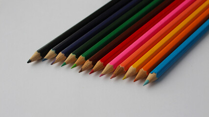 Wooden colored pencils isolated on white background. Creation. Place for text.	