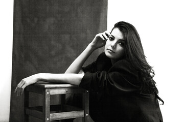 Portrait of a young happy woman isolated on a blackboard.