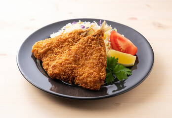 Fried horse mackerel served on a plate on a wooden background