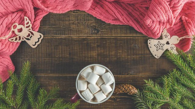 Christmas holiday composition of coffee with marshmallows on dark wood background table. Stop motion animation with Happy Holidays text