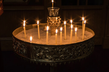 Beeswax candles in Candelabrum candles in sand ornate brass holder