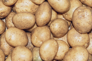 Pile of fresh organic potatoes in a wicker basket.