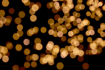 Bokeh light of golden, orange light on nighttime, blurring background. Christmas and New Year holidays template